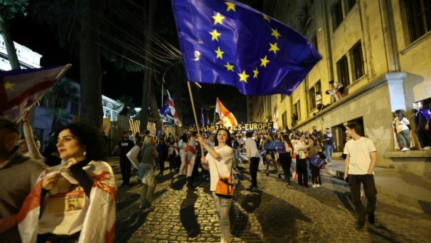 Une manifestante brandit un drapeau européen pendant une manifestation contre le projet de loi sur l