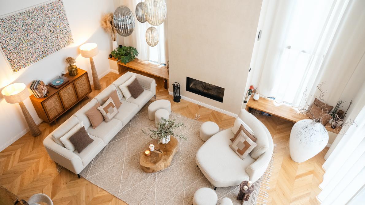 Une chemin&eacute;e XXL recouverte d&rsquo;un enduit en tadelakt, trait&eacute; comme une &oelig;uvre d&rsquo;art et encadr&eacute;e de larges baies vitr&eacute;es ouvertes sur un jardin paysager luxuriant.